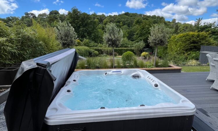 Hot Tub with blue skies and woodland backdrop
